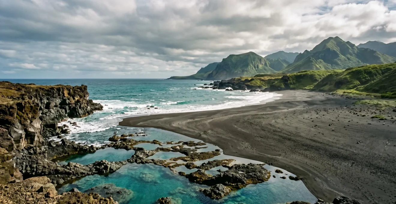 Dramatic volcanic island coastline showcasing diverse geological features from rocky cliffs to sandy beaches