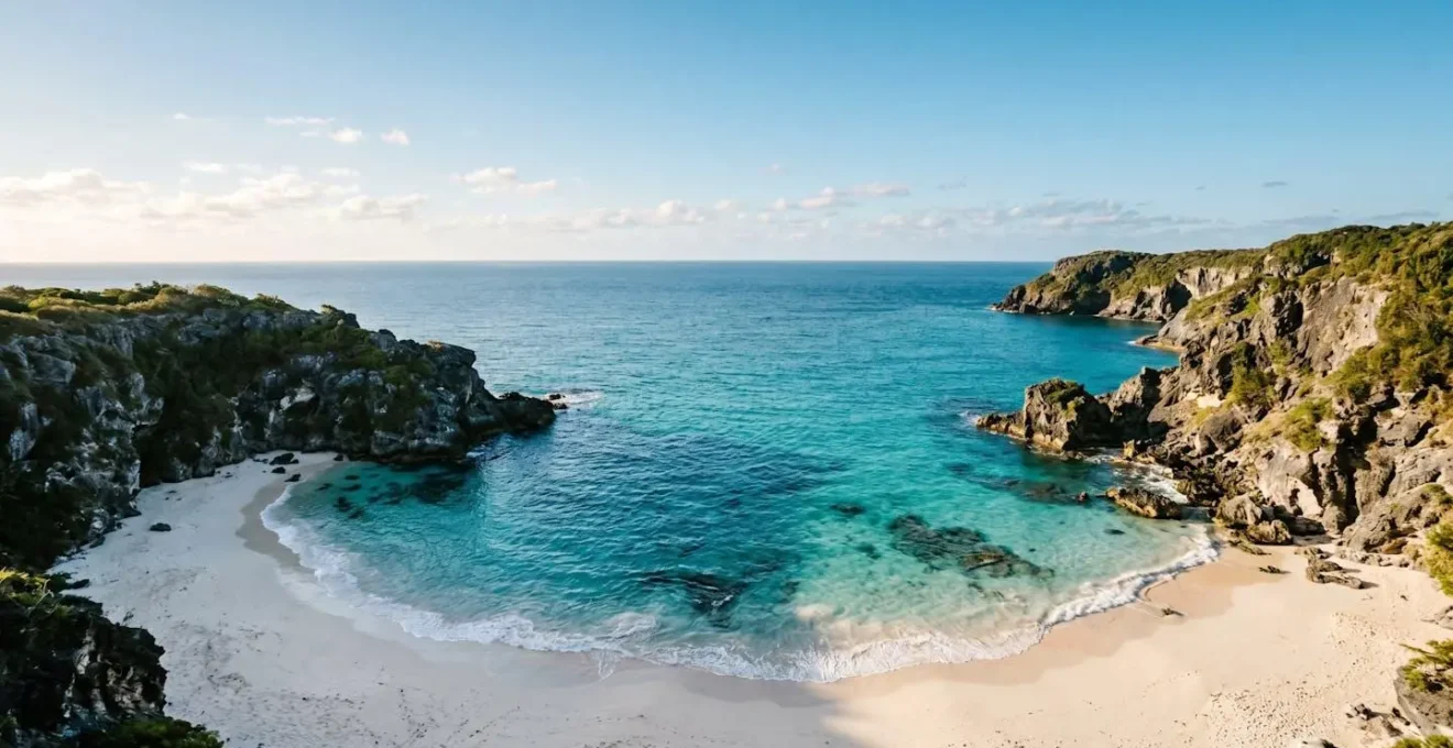 Pristine secluded beach cove with turquoise water and dramatic cliffs, symbolizing the tension between sharing natural beauty and preserving its secrecy