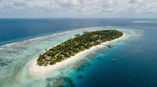 Aerial view of tropical island with diverse accommodation options from beachfront hotels to secluded villas