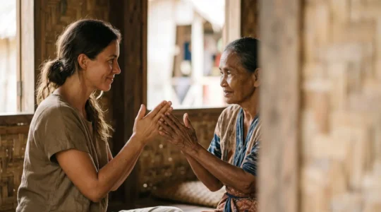 Traveler respectfully engaging with island community member in a traditional setting