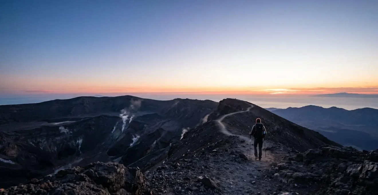 Hikers ascending volcanic crater trail with safety gear on remote island volcano